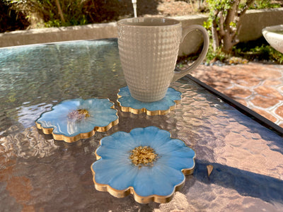 Handmade Baby Sky Blue and Gold Resin Flower Shaped Coasters Set - Jasmin Renee Art - Three Coasters with Cup on Table Outside Gold Rim Edges