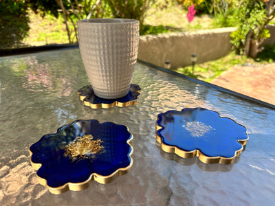 Handmade Deep Ocean Blue and Gold Resin Flower Shaped Coasters Set - Jasmin Renee Art - Three Coasters with Cup on Table Gold Rim Edges